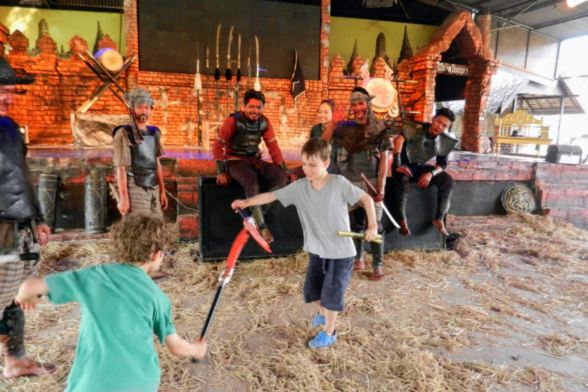 Kids enjoying battle reenactments at Ayutthaya Floating Market