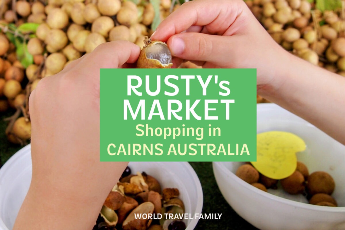 Photo of tropical fruit at Rusty's Market Cairns. Text reads "Rusty's Market, Shopping in Cairns Australia