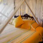 Ambalangoda Beach Villa, The Max Wadiya Bedroom with four posted bed and beautiful linen at the Max Wadiya villa. The bedroom has sea views.