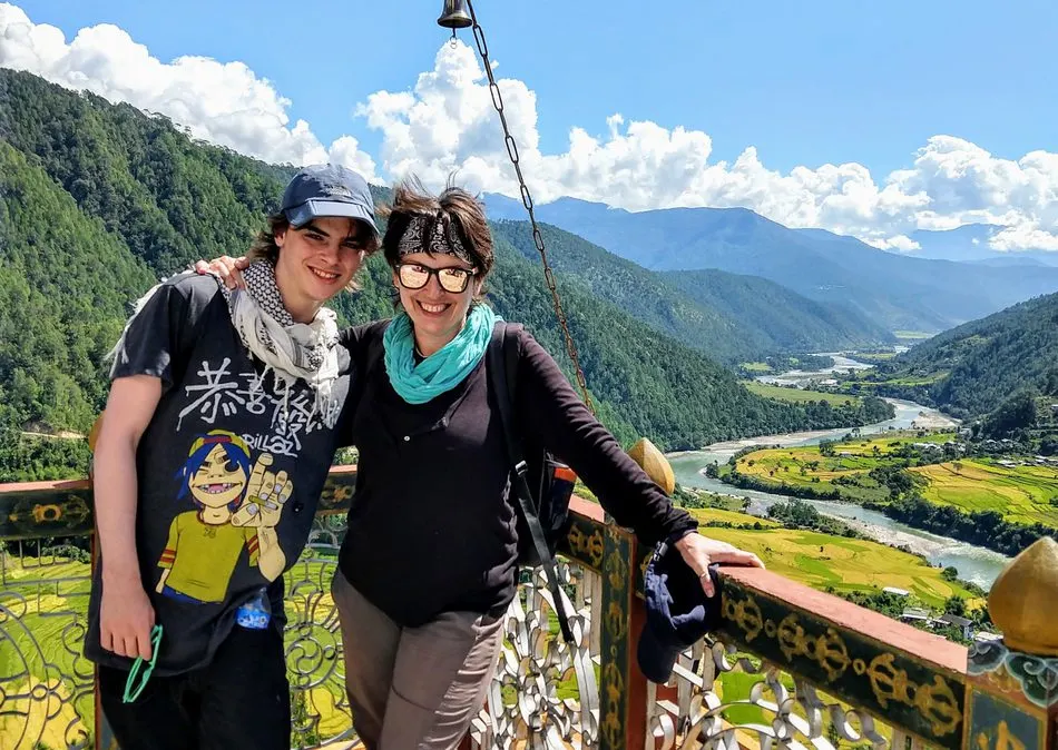 Travel with teenagers mum and son hike top of the hill