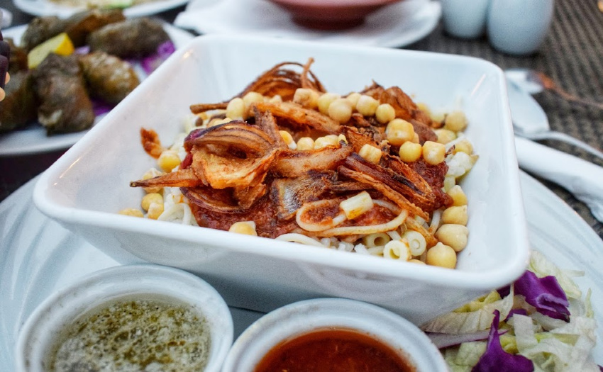 Food in Egypt Koshari pasta and lentil salad with chick peas onions and spicy sauce