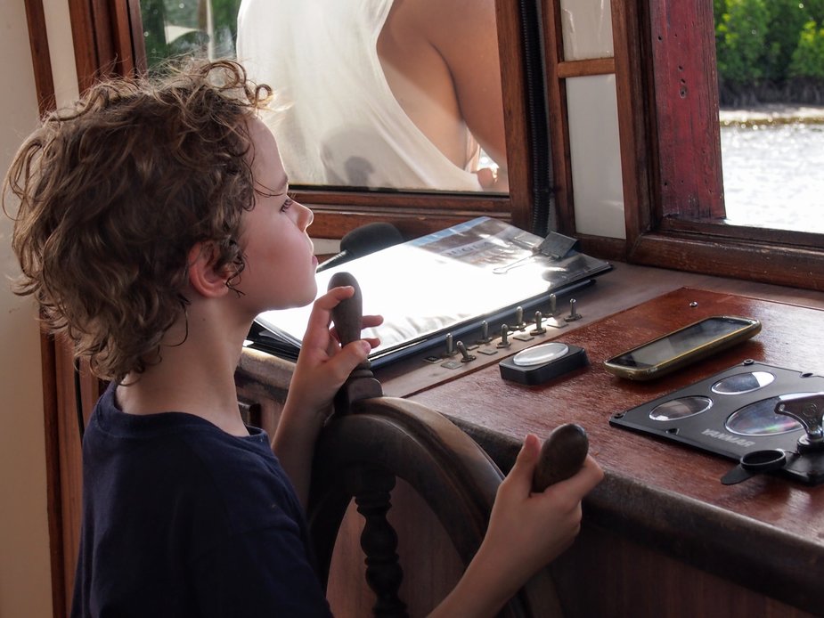 Child driving The Lady Douglas River Cruise Boat in Port Douglas Australia